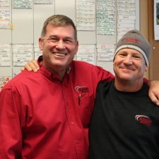 two men at academy roofing smiling