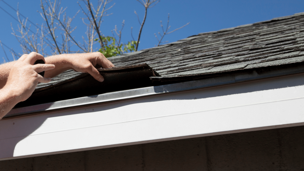 Checking under the shingles of a roof.